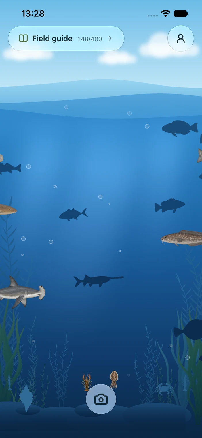 Catcharium’s animated aquarium home screen with fish, underwater plants, and the camera button